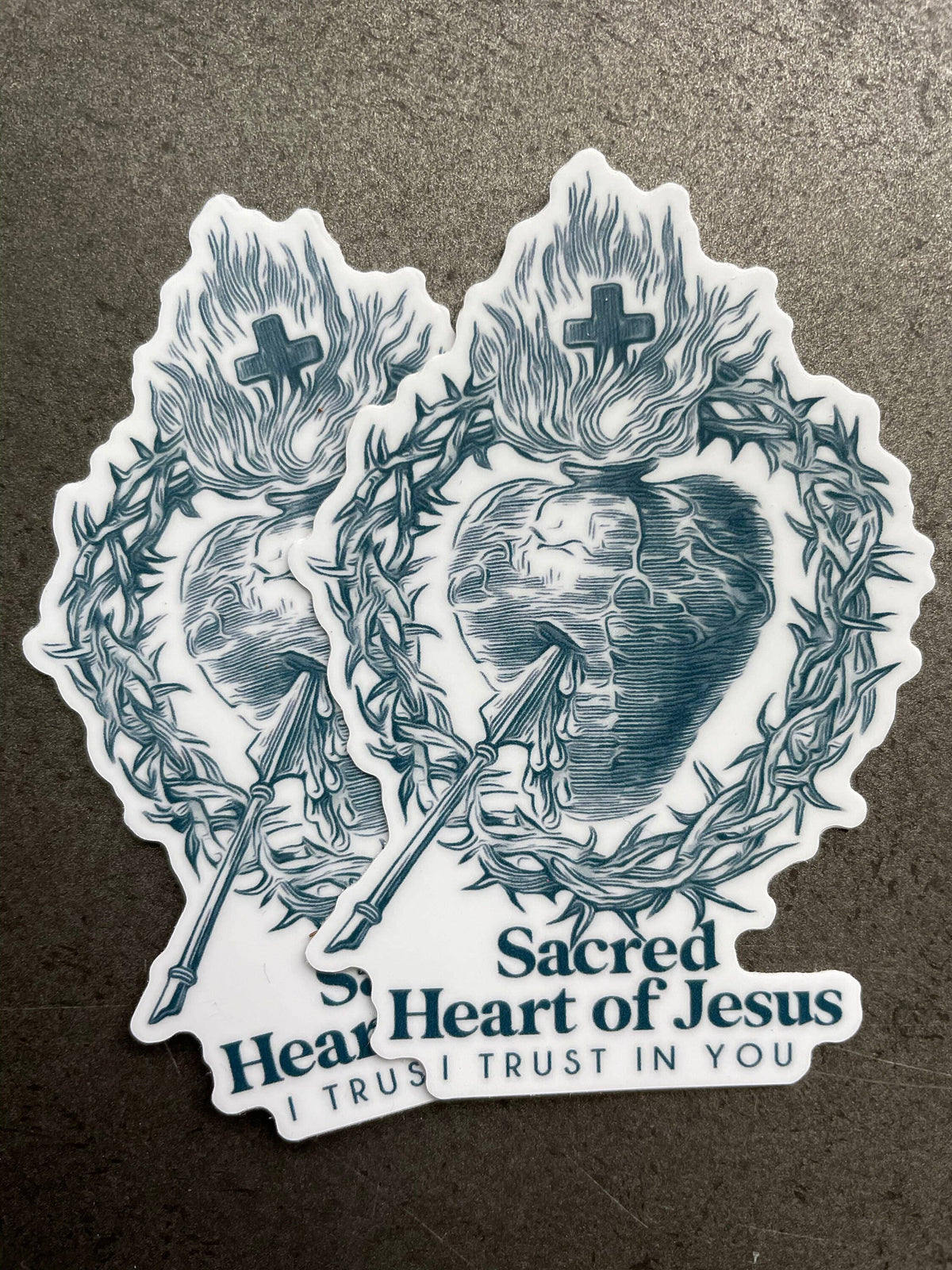 Sticker of Sacred Heart of Jesus design with crosses and thorns on a textured background