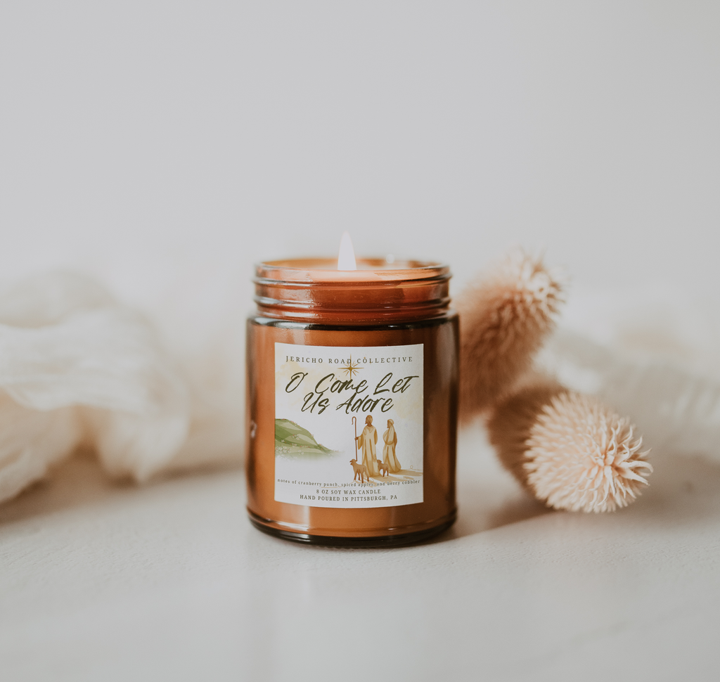 Candle in a glass jar with a label on a light background
