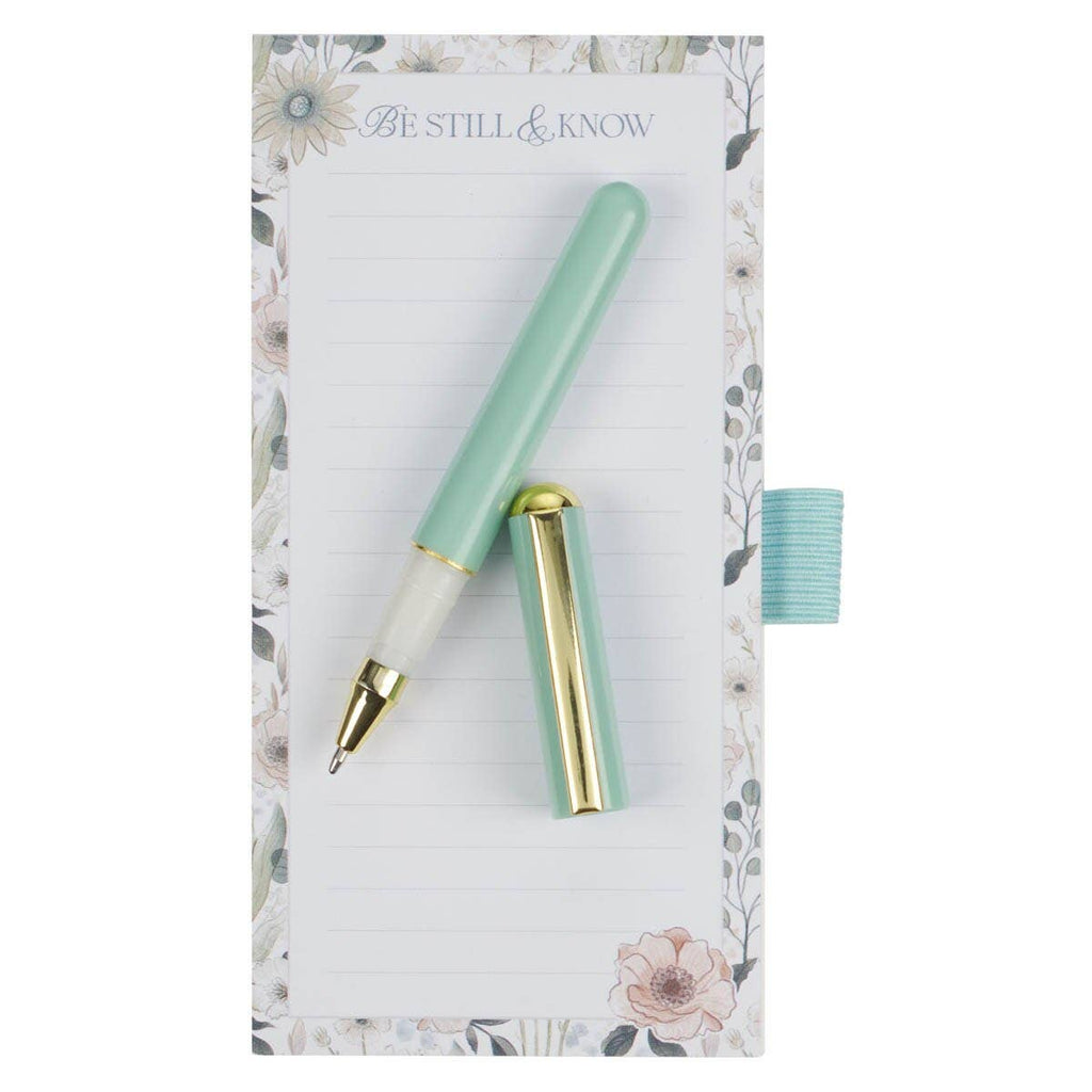 Mint green pen with gold accents on a floral-patterned card