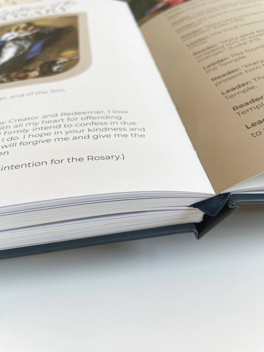 Open book with text and a photo on a white surface