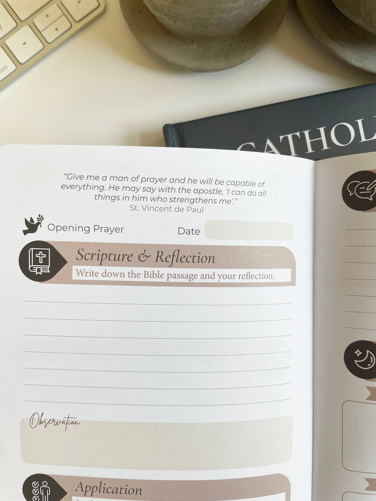 Open notebook with prayer and reflection sections on a desk