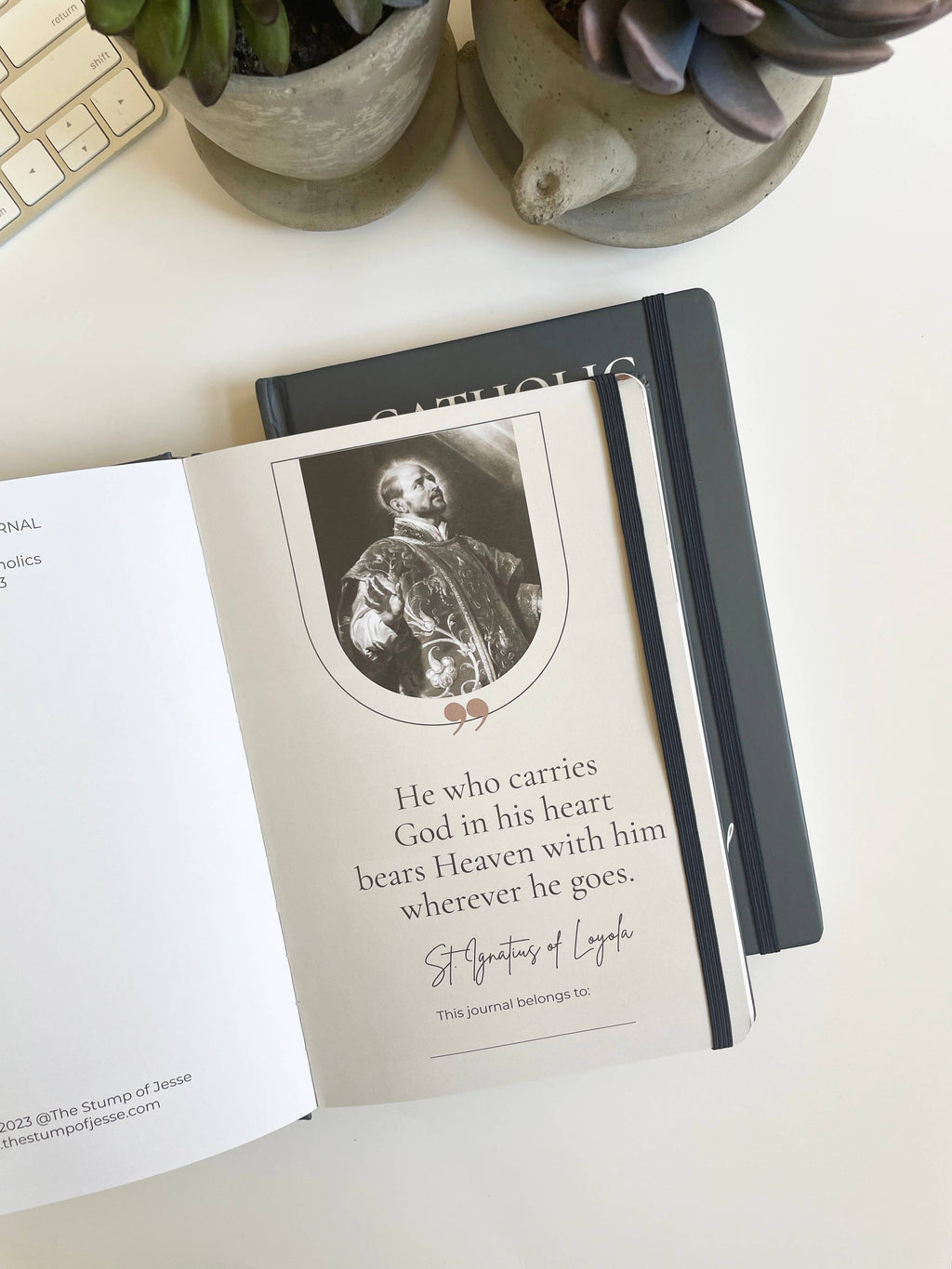 Journal with a quote and image of a man, placed on a surface with plants in the background.