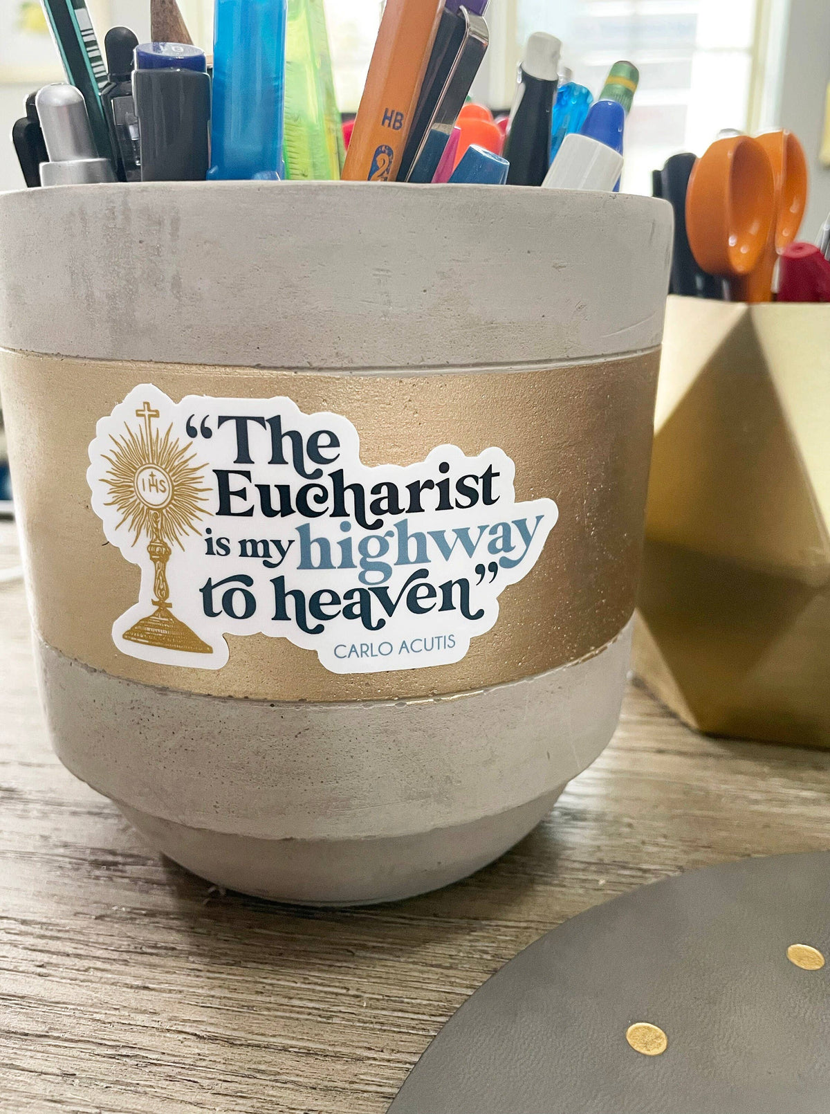 Ceramic container with a religious quote on a desk