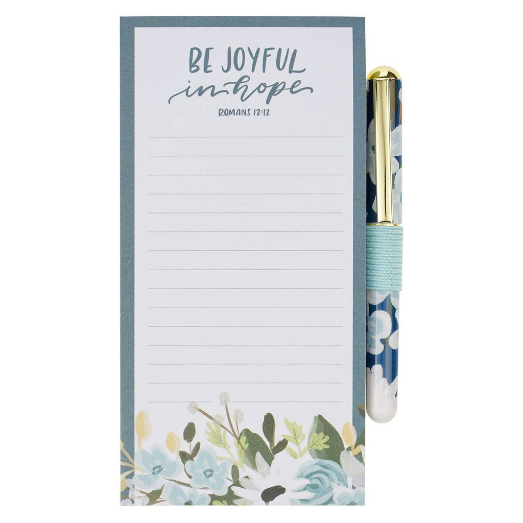 Notepad with floral design and motivational quote, accompanied by a matching pen.