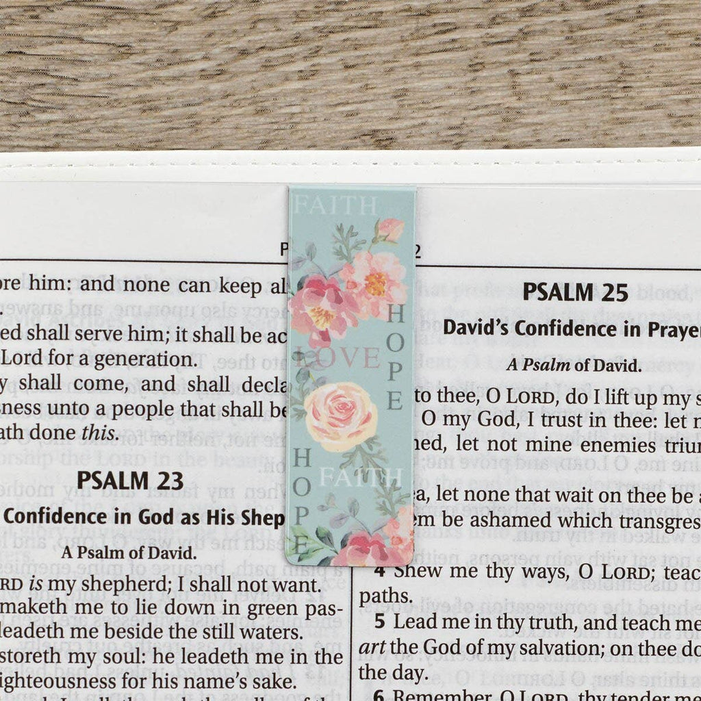 Floral bookmark on a page of a Bible with visible text