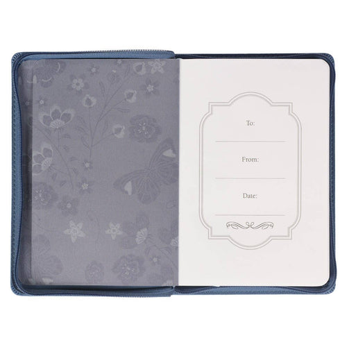 Floral and butterfly design on open blue notebook journal with a white page inside.