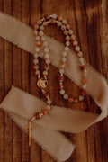 Rosary beads and a cross on a wooden surface