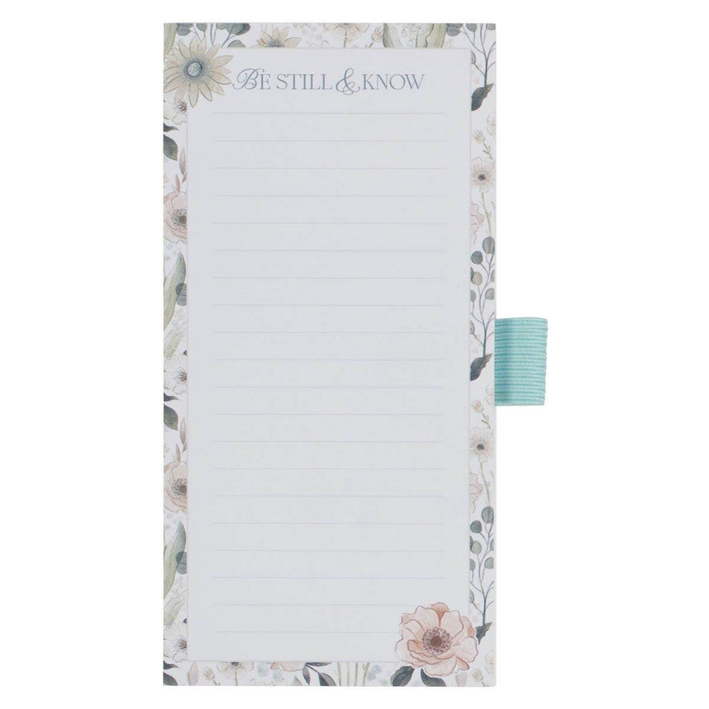 Notepad with floral design and 'Be Still & Know' text on a white background
