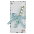 Mint green pen with gold clip on floral-patterned card, 'Be Still & Know' text visible