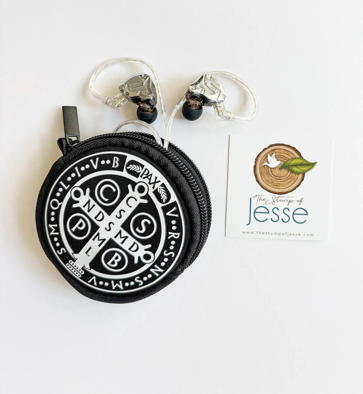 St. Benedict Medal Pouch with white emblem and ear buds on a white background.