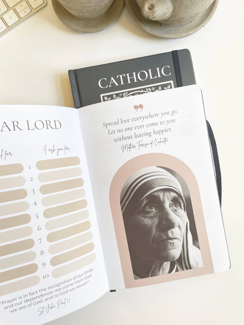 Open book with a portrait of Mother Teresa on a white surface